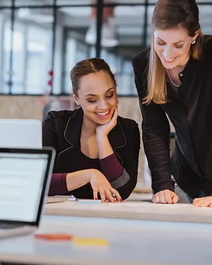 two-young-woman-at-office-working-on-a-n